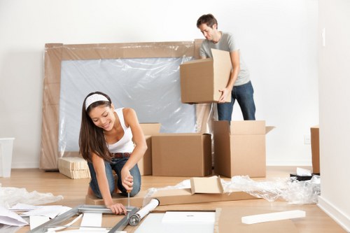 Professional team handling a piano removal in Barnet with protective equipment